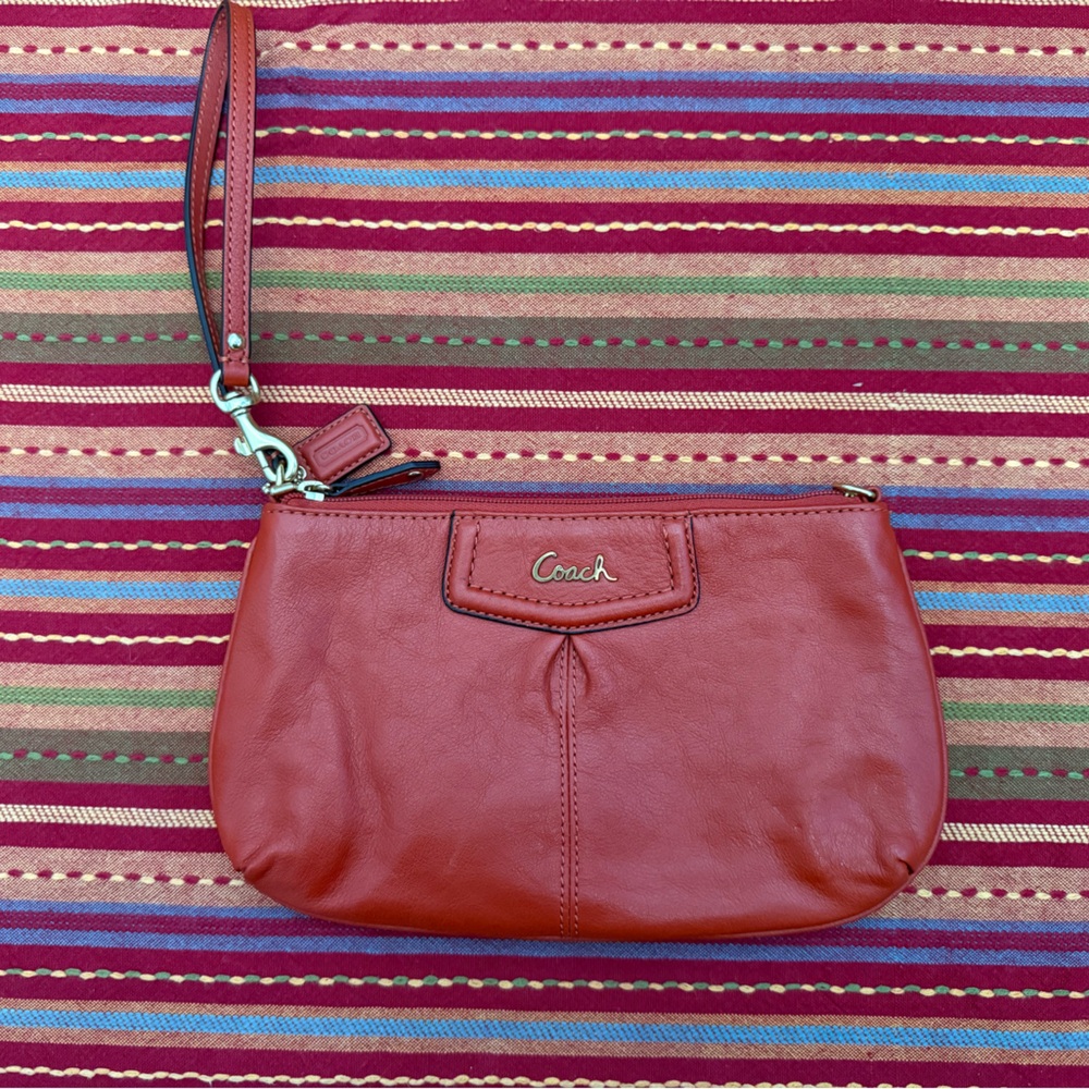 coach burnt orange wristlet purse